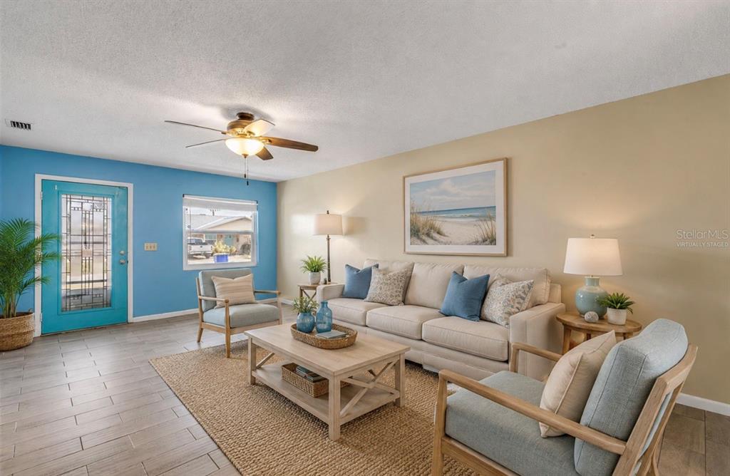 26 Laughing Gull Lane Edgewater, FL 32141 - Photo 4 of 66 a living room with furniture a chandelier and a window