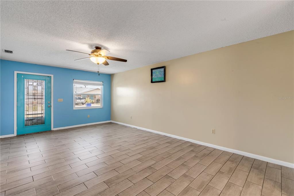 26 Laughing Gull Lane Edgewater, FL 32141 - Photo 5 of 66 wooden floor in an empty room with a window