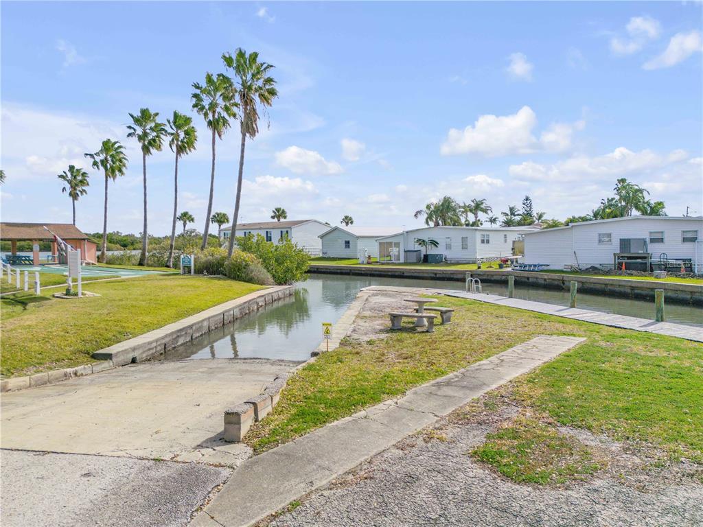 26 Laughing Gull Lane Edgewater, FL 32141 - Photo 51 of 66 a view of a swimming pool with a garden