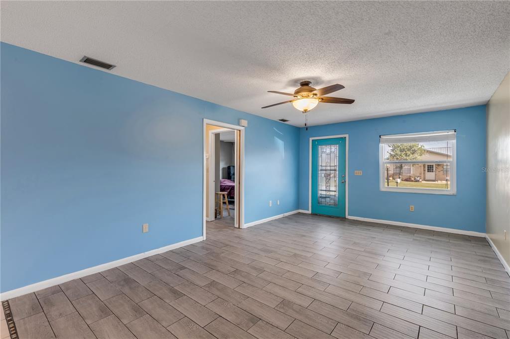 26 Laughing Gull Lane Edgewater, FL 32141 - Photo 7 of 66 a view of an empty room with chandelier fan and window