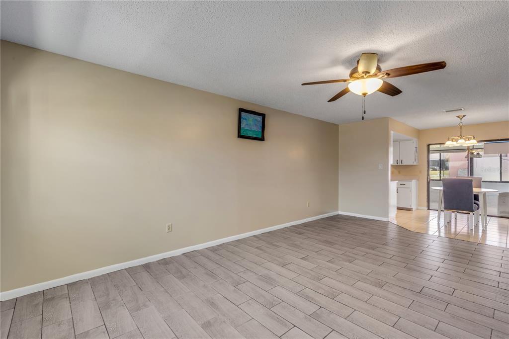 26 Laughing Gull Lane Edgewater, FL 32141 - Photo 8 of 66 wooden floor in an empty room with a window