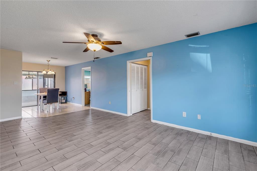 26 Laughing Gull Lane Edgewater, FL 32141 - Photo 10 of 66 a view of an empty room with window and wooden floor