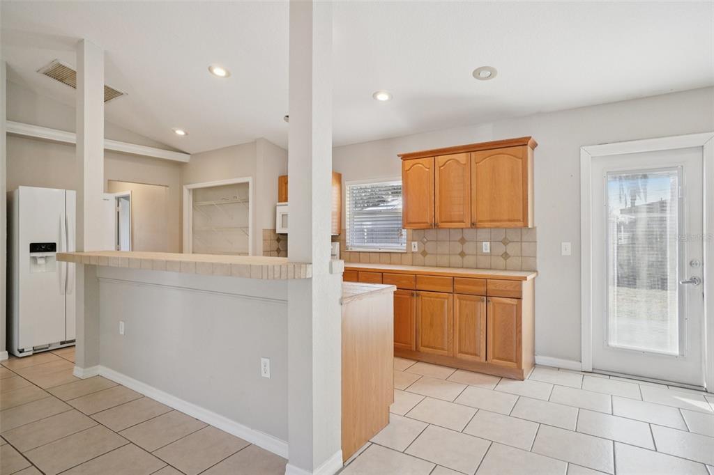 13210 Maple Street Odessa, FL 33556 - Photo 16 of 34 a spacious bathroom with a granite countertop sink a mirror and a shower
