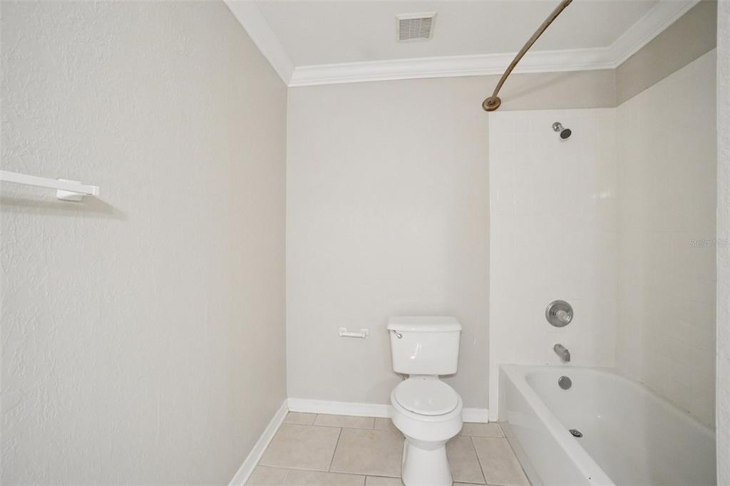 13210 Maple Street Odessa, FL 33556 - Photo 18 of 34 a bathroom with a toilet and a shower