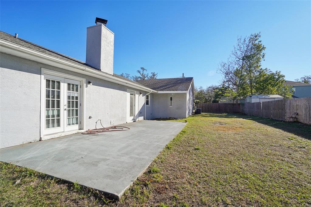 13210 Maple Street Odessa, FL 33556 - Photo 33 of 34 a view of a house with a backyard and tree
