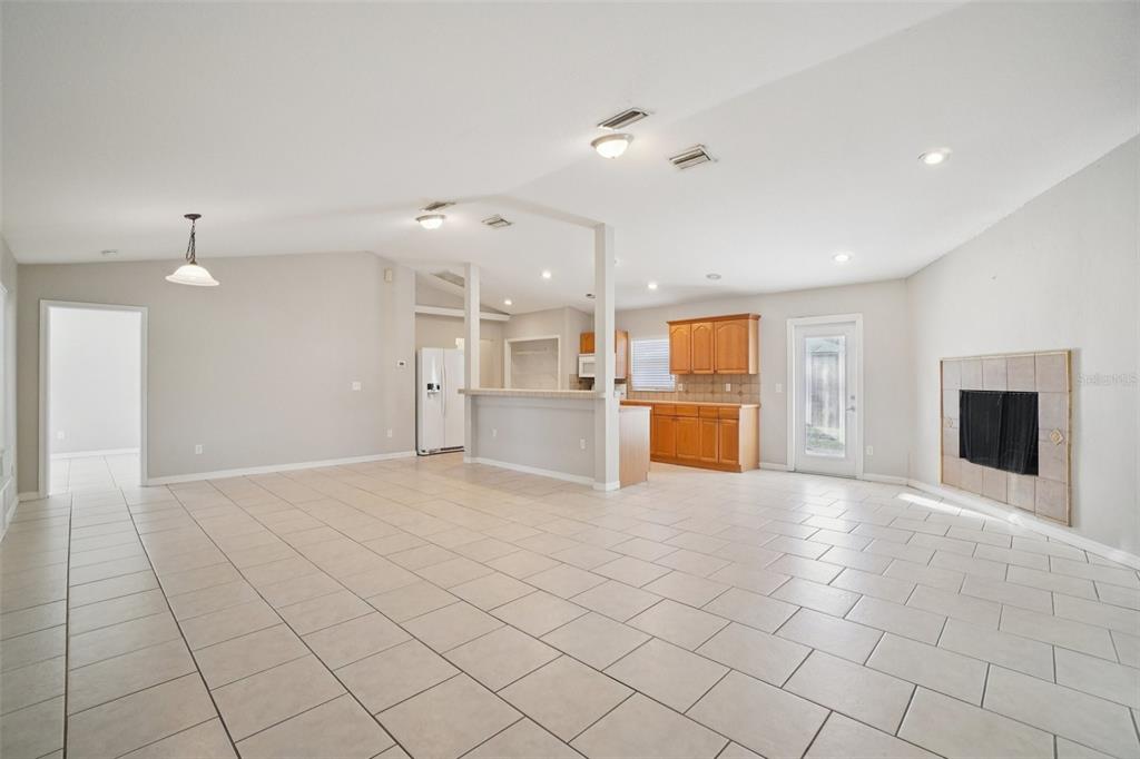 13210 Maple Street Odessa, FL 33556 - Photo 5 of 34 a view of an empty room with kitchen and window