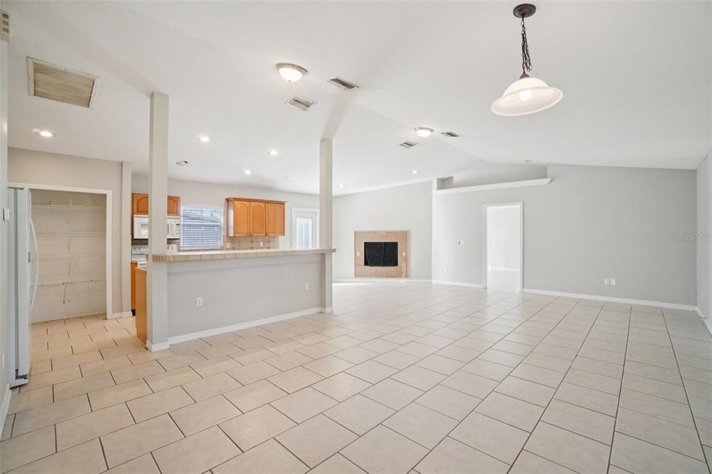 13210 Maple Street Odessa, FL 33556 - Photo 8 of 34 a view of a kitchen with furniture and an empty room