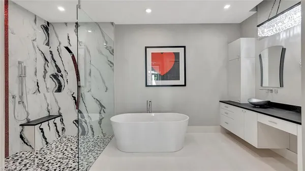 a bathroom with a granite countertop sink a mirror and a shower