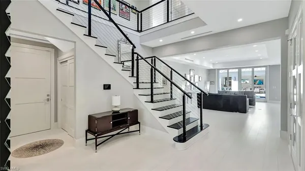 a view of a hallway with wooden floor and windows