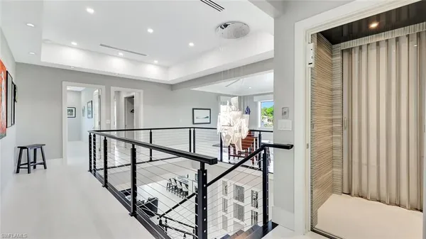 a view of a hallway with wooden floor and furniture