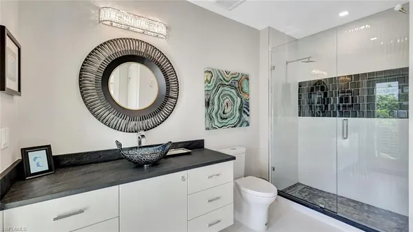 a bed sitting in a spacious bedroom next to a window