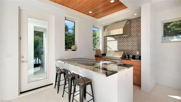 a view of a dining room with furniture and a chandelier