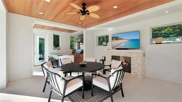 a view of a dining room with furniture and chandelier