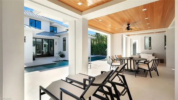 a view of a house with pool and a yard