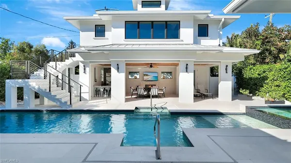 a view of swimming pool with outdoor seating