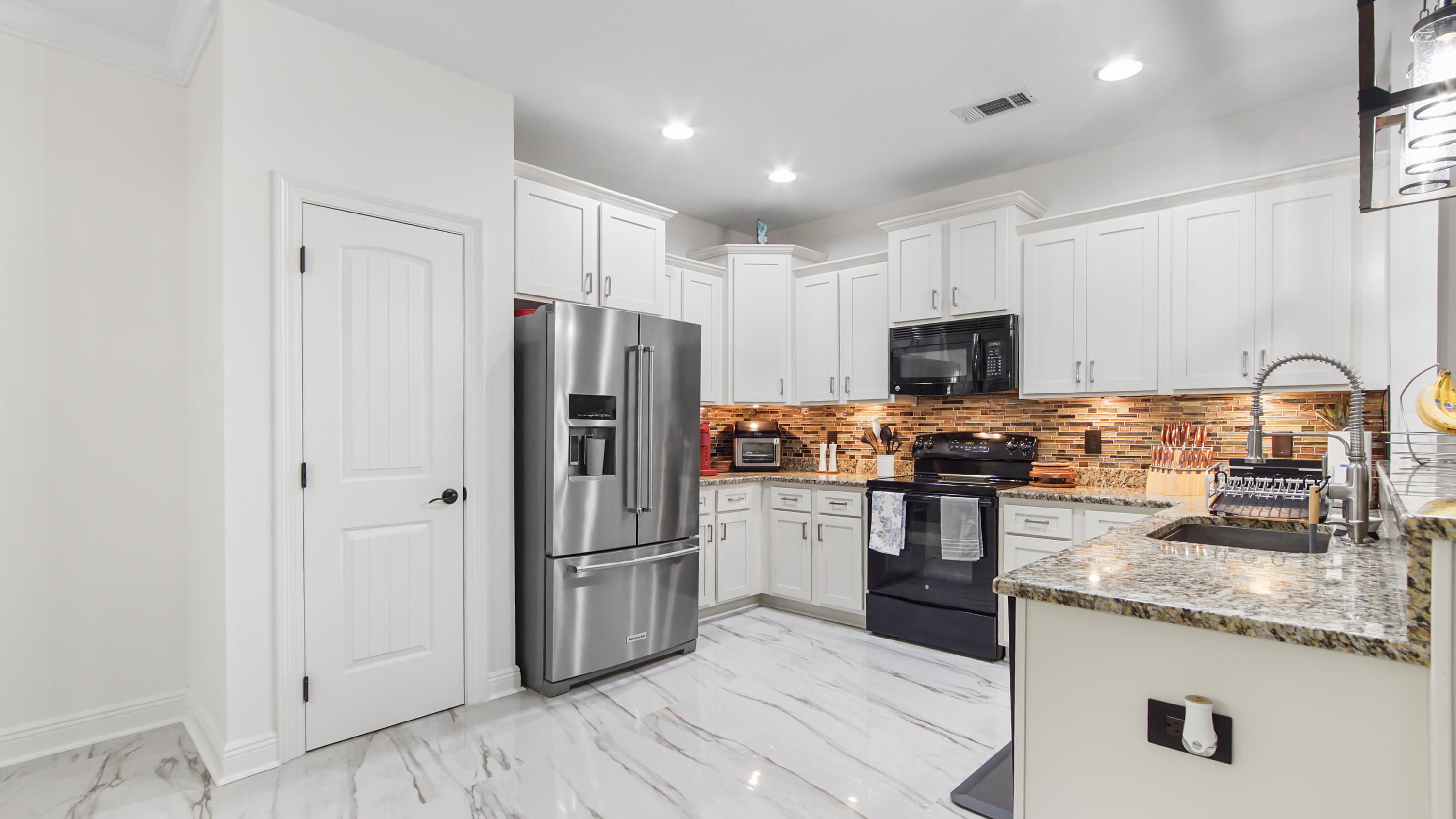 123 Big Oak Lane Santa Rosa Beach, FL 32459 - Photo 12 of 50 a kitchen with granite countertop stainless steel appliances and wooden cabinets
