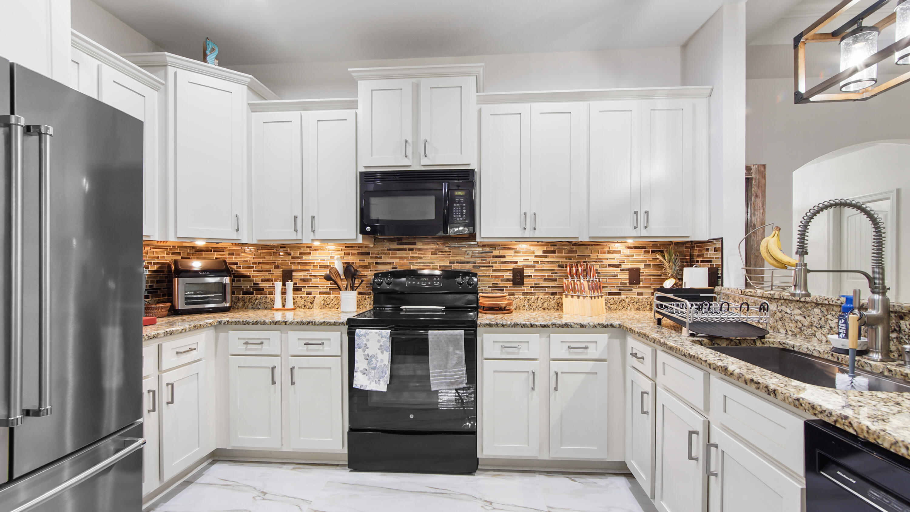 123 Big Oak Lane Santa Rosa Beach, FL 32459 - Photo 13 of 50 a kitchen with granite countertop a sink stove and refrigerator