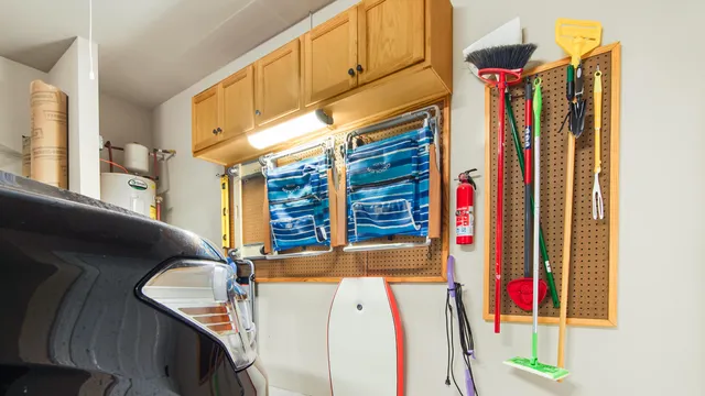 a view of a house with a small yard plants and large tree