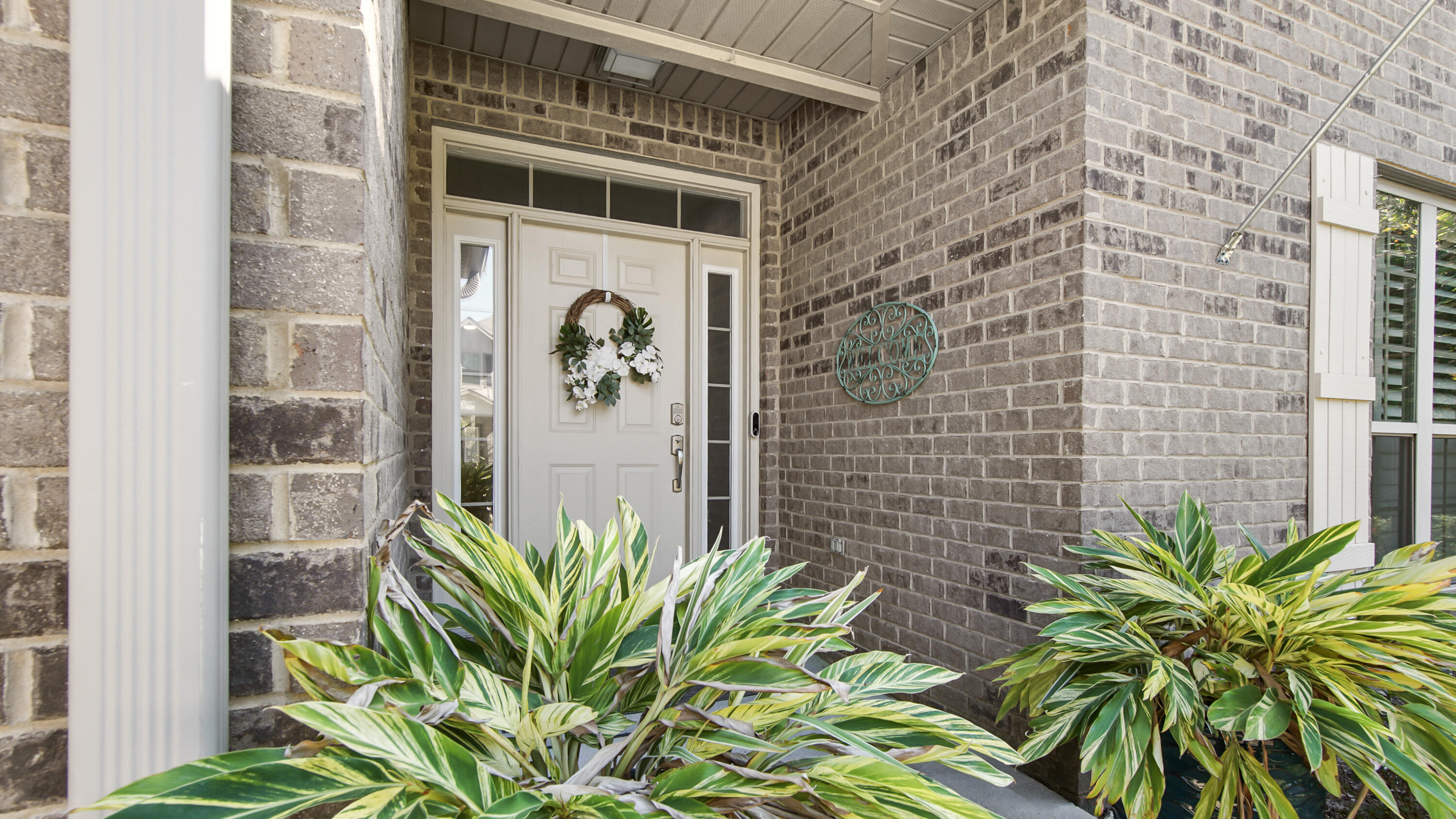 123 Big Oak Lane Santa Rosa Beach, FL 32459 - Photo 6 of 50 a plant is sitting in front of a door