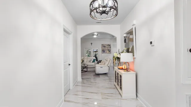 a view of a hallway with living room