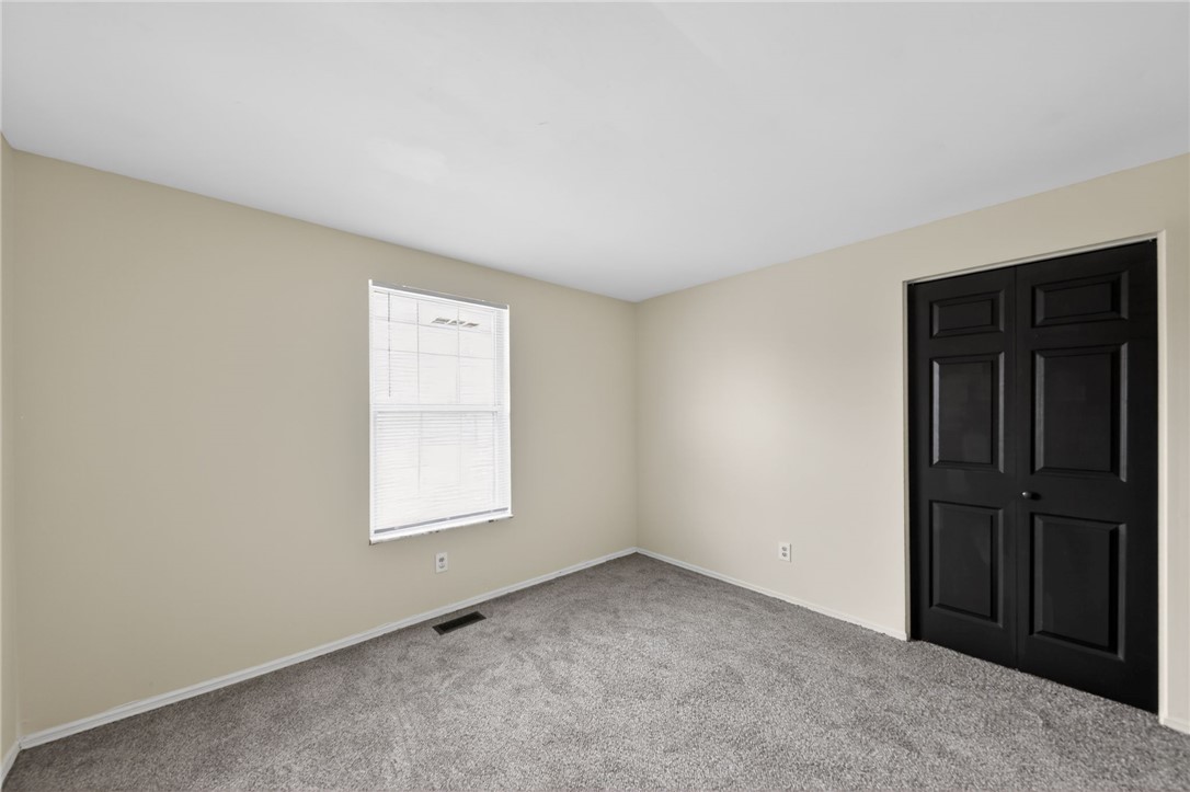 6070 Charlesgate Road Huber Heights, OH 45424 - Photo 10 of 29 This spacious bedroom offers ample natural light and a neutral palette, perfect for personalized design.