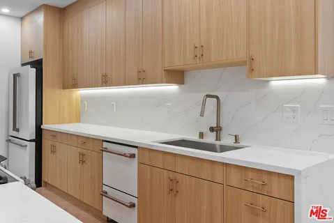 a kitchen with a sink stove and cabinets