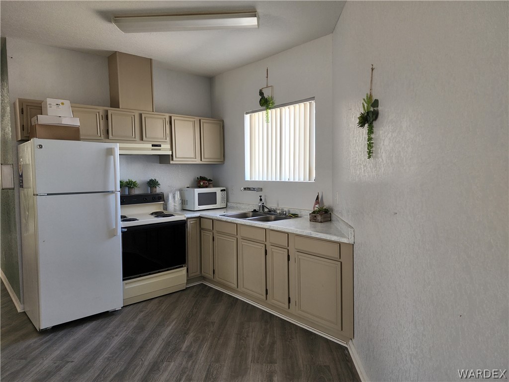 2066 East El Rodeo Road, Unit 31 Fort Mohave, AZ 86426 - Photo 11 of 12 a kitchen with a refrigerator sink and cabinets