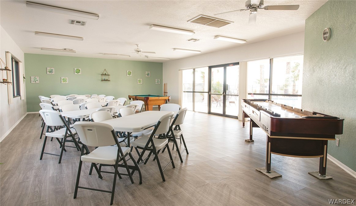 2066 East El Rodeo Road, Unit 31 Fort Mohave, AZ 86426 - Photo 9 of 12 a view of a dining room with furniture window and wooden floor