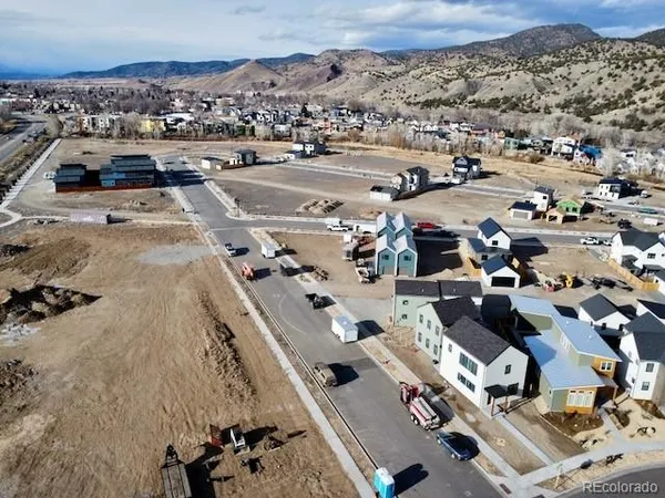 an aerial view of a house with sitting space garden and mountain view