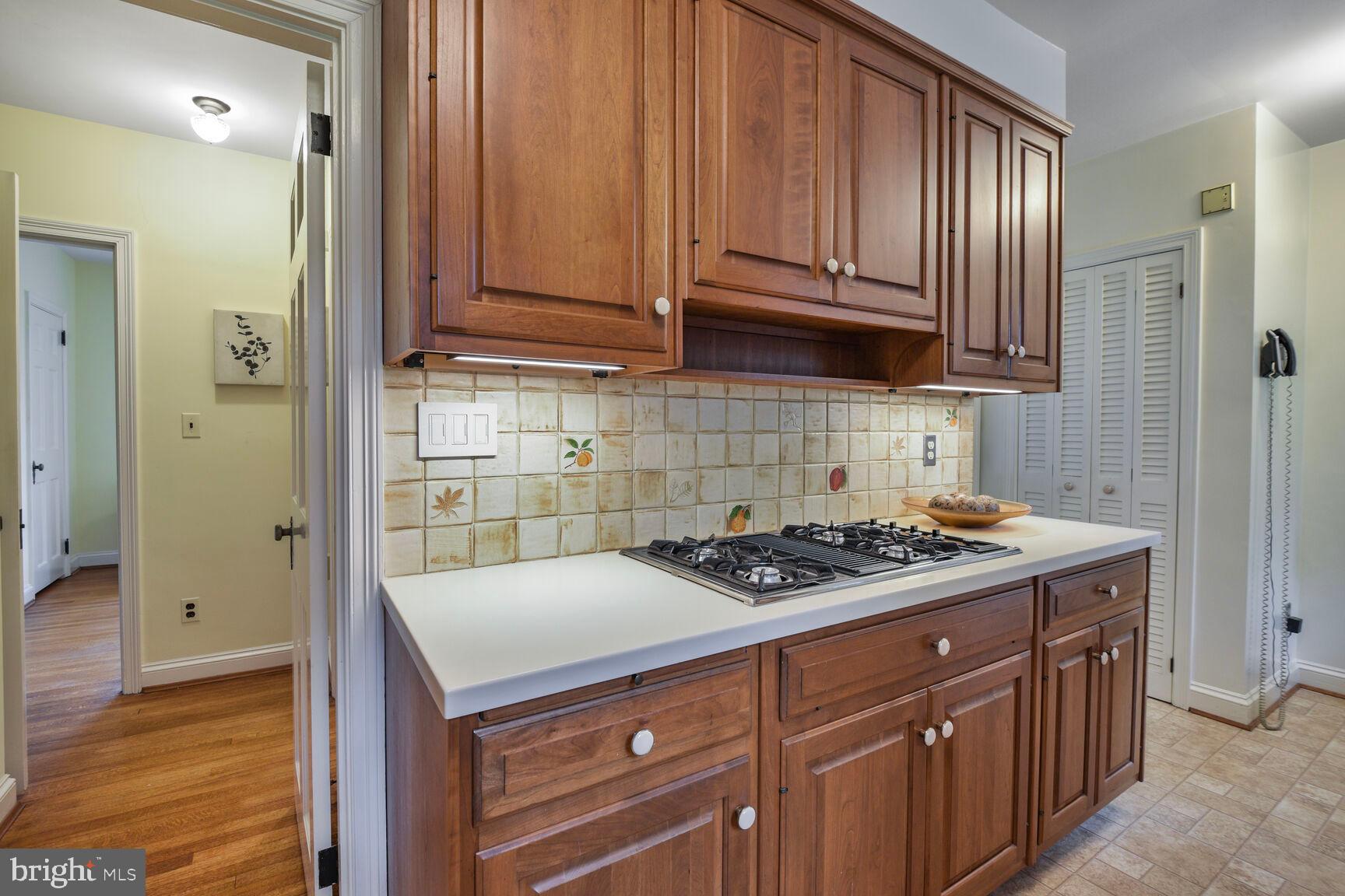 1200 Highland Drive Silver Spring, MD 20910 - Photo 11 of 39 Custom cabinets surround the gas cooktop