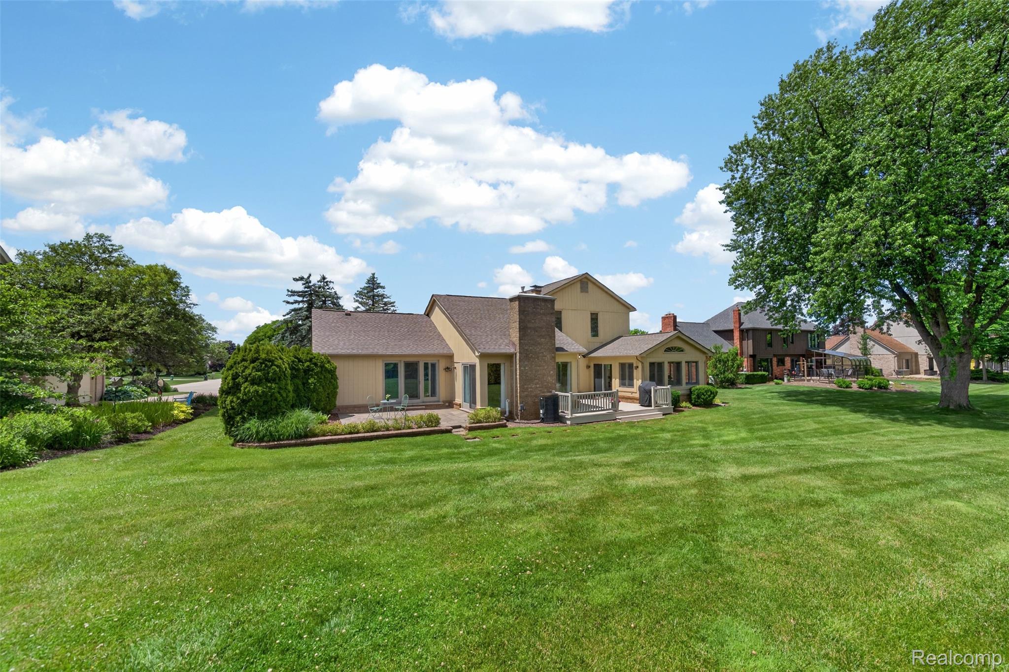 1236 Chaffer Drive Rochester, MI 48306 - Photo 56 of 76 Expansive rear yard featuring a large green lawn and mature trees