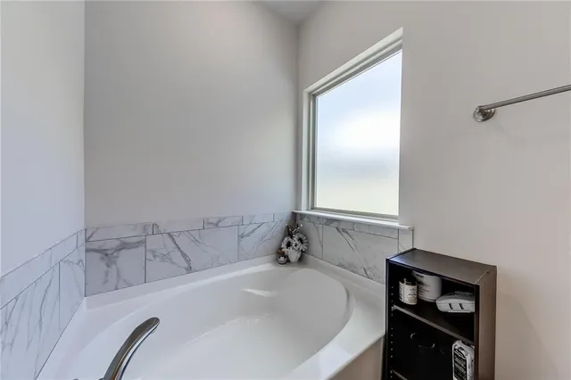 a bathroom with a shower and a glass door