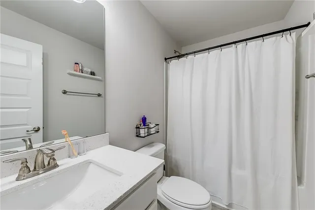 a bedroom with bed and a large window