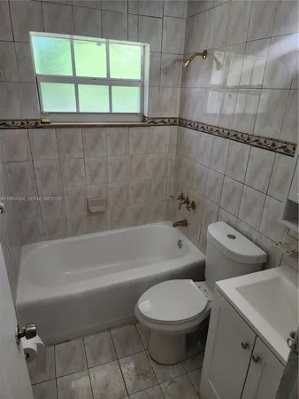 a bathroom with a toilet a sink and bathtub