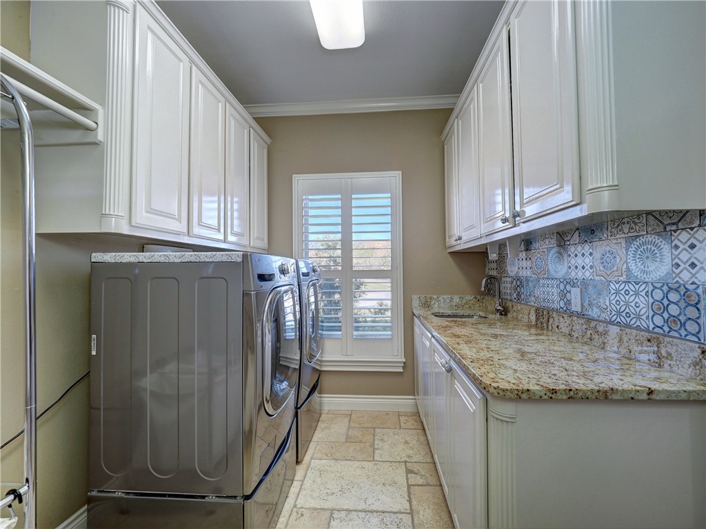 204 Black Diamond Road Portland, TX 78374 - Photo 13 of 40 a kitchen with granite countertop a sink a stove and a refrigerator