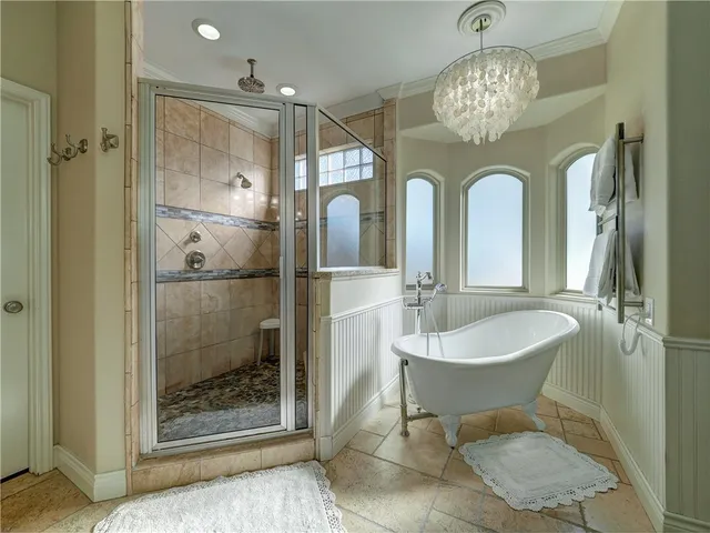 a bathroom with a granite countertop sink a large mirror and a shower