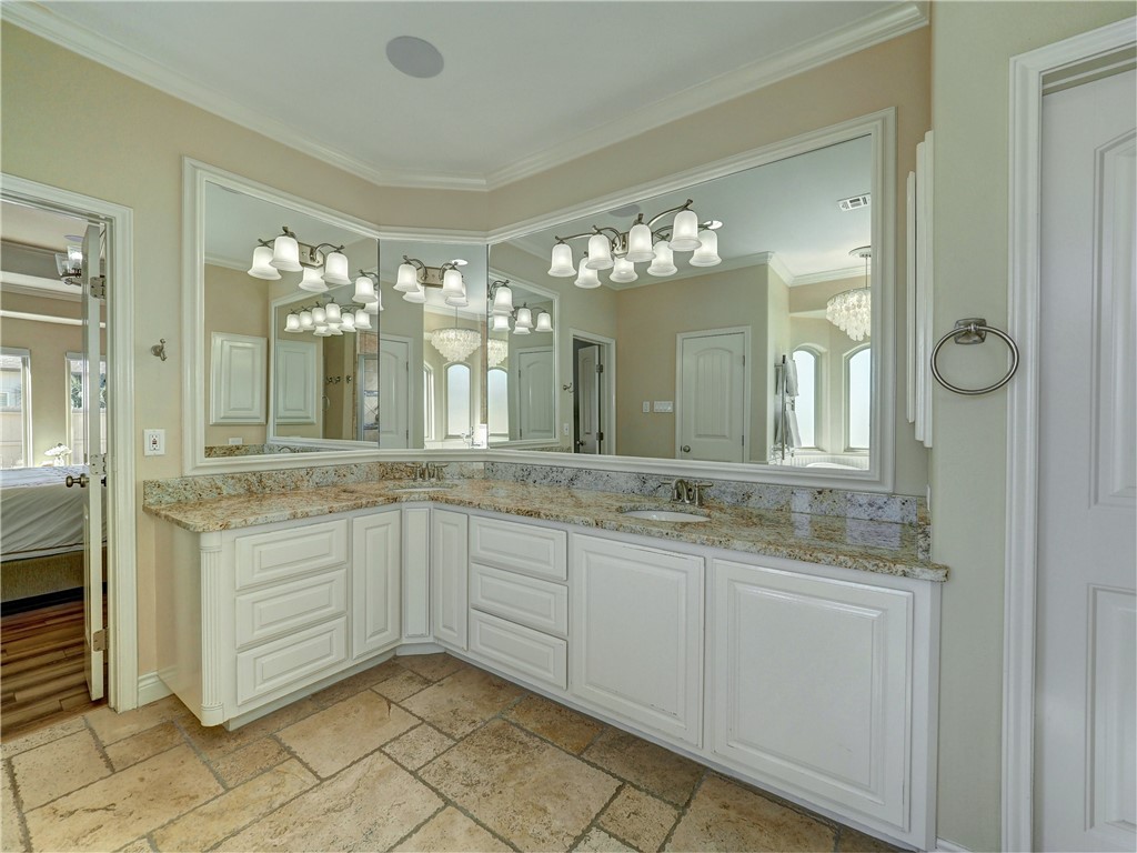 204 Black Diamond Road Portland, TX 78374 - Photo 16 of 40 a bathroom with a granite countertop sink a large mirror and a shower
