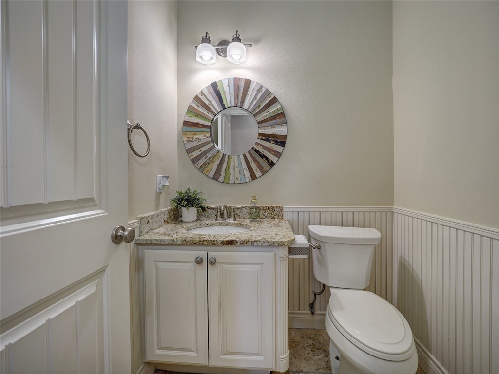 204 Black Diamond Road Portland, TX 78374 - Photo 19 of 40 a bathroom with a granite countertop toilet sink and mirror
