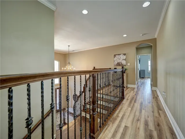 a view of a hallway with wooden floor and staircase