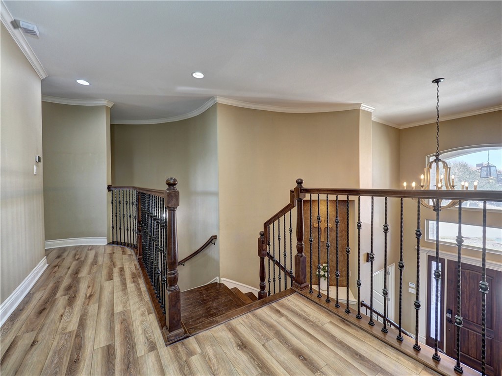 204 Black Diamond Road Portland, TX 78374 - Photo 23 of 40 a view of a hallway with wooden floor and staircase
