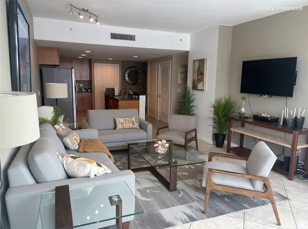 a living room with furniture and a flat screen tv