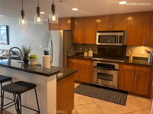 a kitchen with stainless steel appliances a sink stove and refrigerator