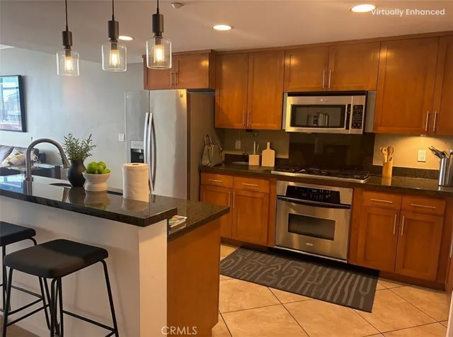 a kitchen with stainless steel appliances a sink stove and refrigerator