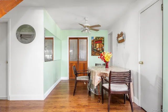 a view of a dining room with furniture wooden floor and a chandelier
