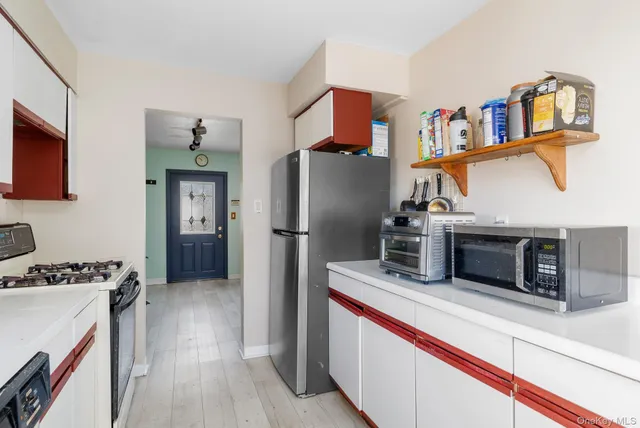 a kitchen with stainless steel appliances a refrigerator and a stove top oven