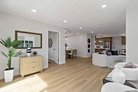 a living room with fireplace furniture and a wooden floor