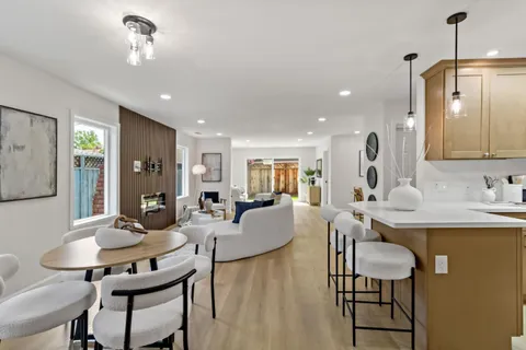 a view of a dining room with furniture and wooden floor