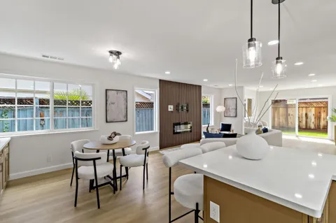 a kitchen with stainless steel appliances granite countertop a refrigerator a sink and a stove