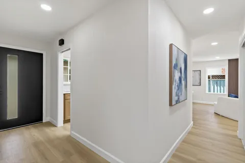 a spacious bathroom with a double vanity sink toilet and a tub