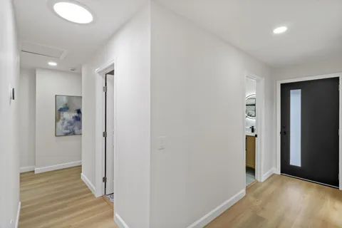 a bedroom with a bed and a wooden floor